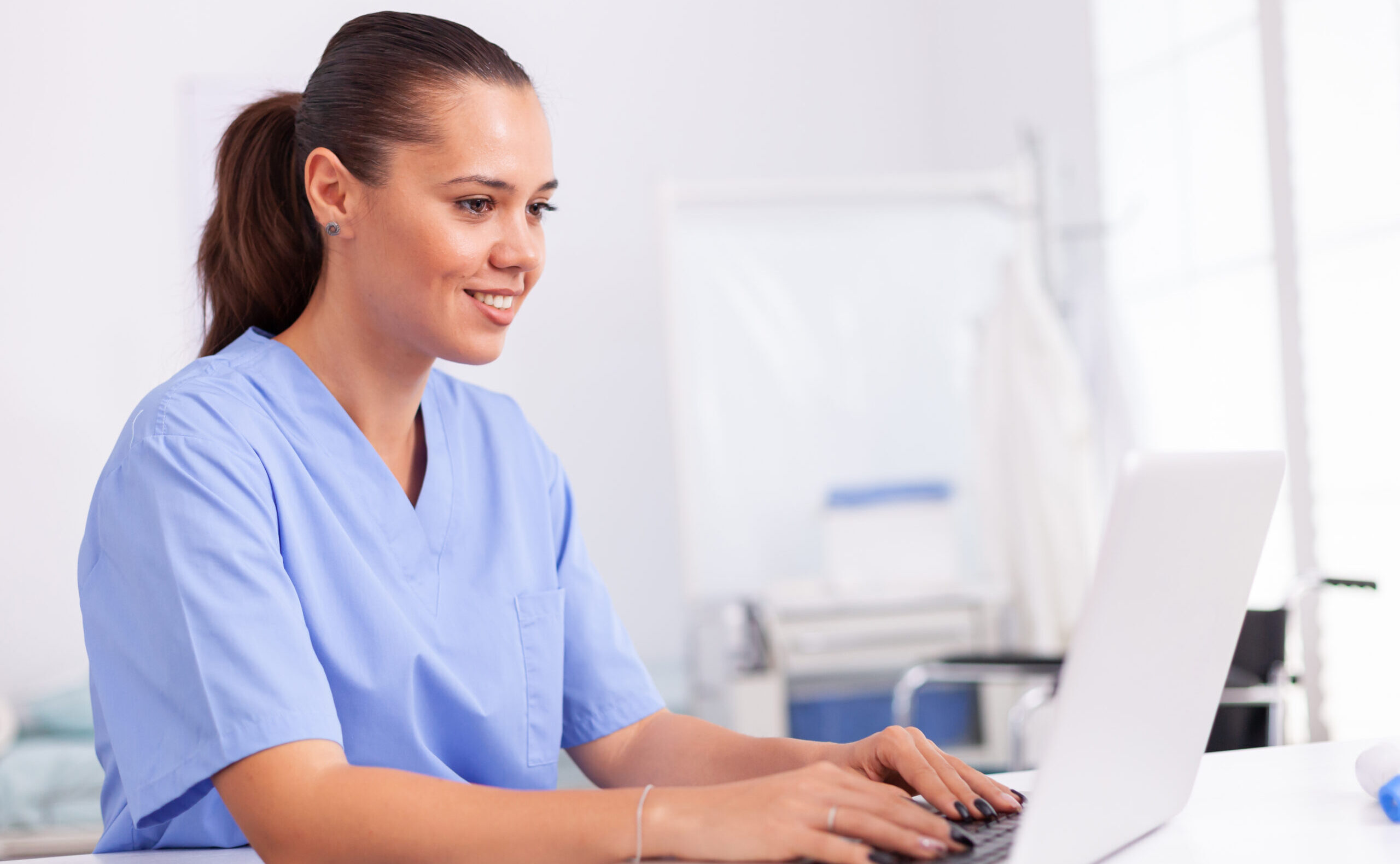 medical nurse uniform using laptop sitting desk hospital office health care physician using computer modern clinic looking monitor medicine profession scrubs.jpg